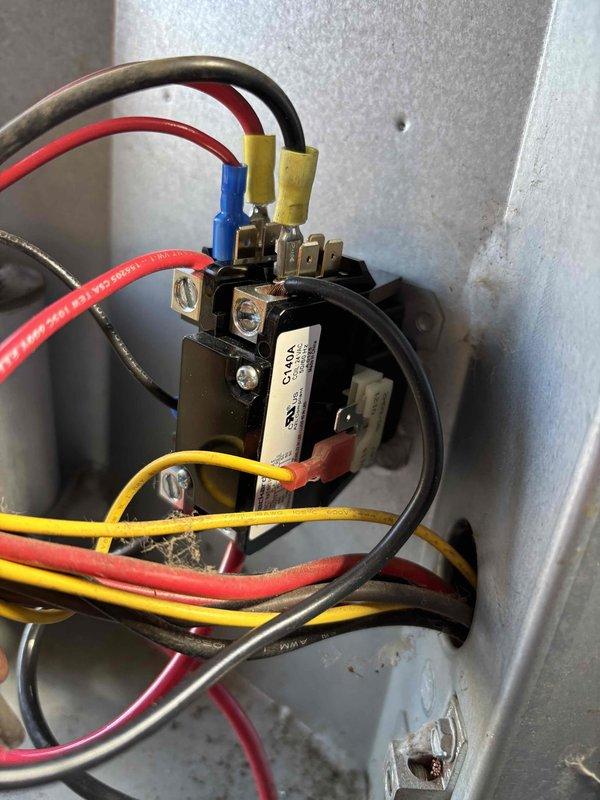 Completed QUOTR-quoted repair on air conditioning system. Reset unit and established proper electrical connections at the contactor. Verified all wire terminations were secure with proper color coding—red, yellow, blue, and black conductors properly landed at terminal points. Inspected internal components including motor housing, fan assembly, and condensate drain pan for proper operation. All components showed normal wear consistent with regular use and were functioning correctly. System tested and confirmed operational upon completion.