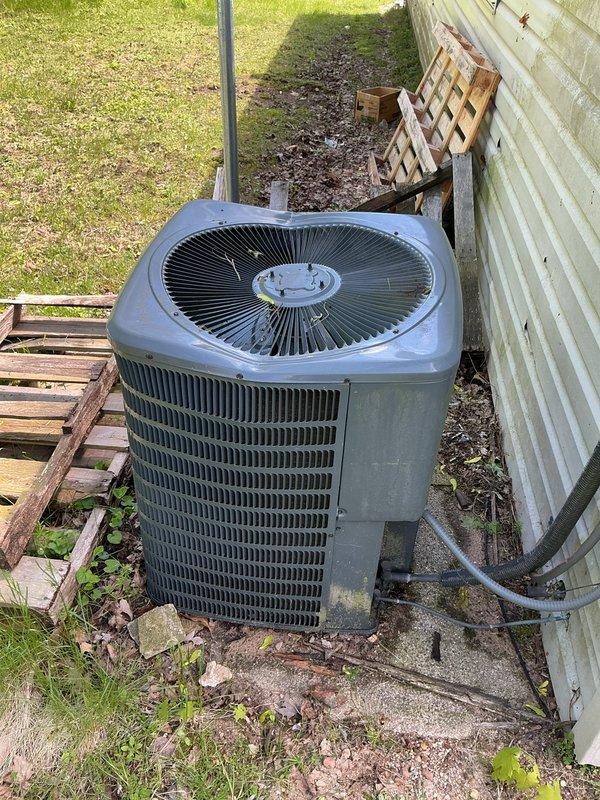 Responded to no cooling complaint on 4-year-old Goodman system with condenser unit not running. Upon arrival, found condenser fan motor failed and debris accumulation in outdoor unit restricting airflow. Removed leaves and organic material from condenser cabinet, tested electrical components, and confirmed fan motor failure. Replaced condenser fan motor, cleared all debris from unit, verified proper amperage draw and capacitor operation. System restored to normal cooling operation with proper airflow and refrigerant pressures. Enrolled customer in annual maintenance program and collected voided check for automatic payment setup as requested.