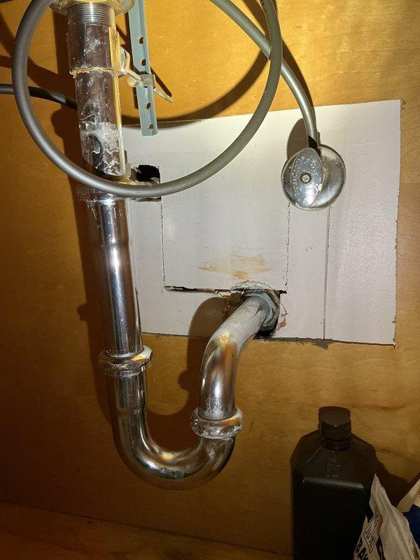 Responded to slow-draining bathroom sink issue. Inspected P-trap assembly and drainage system beneath fixture, finding chrome-plated trap and tailpiece connections in serviceable condition. Examined exposed drain lines in basement crawl space, documenting existing cast iron and PVC piping configuration to verify proper drainage slope and identify potential blockage points. Cleared obstruction and restored proper drainage flow to fixture.
