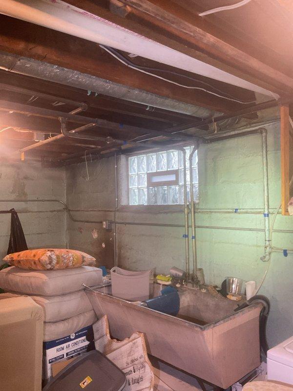 Completed installation of 40-gallon natural gas water heater with 6-year warranty and short configuration in basement utility area. Unit was installed per manufacturer specifications with proper venting, gas line connections, and code-compliant clearances in existing mechanical space alongside other utility systems.