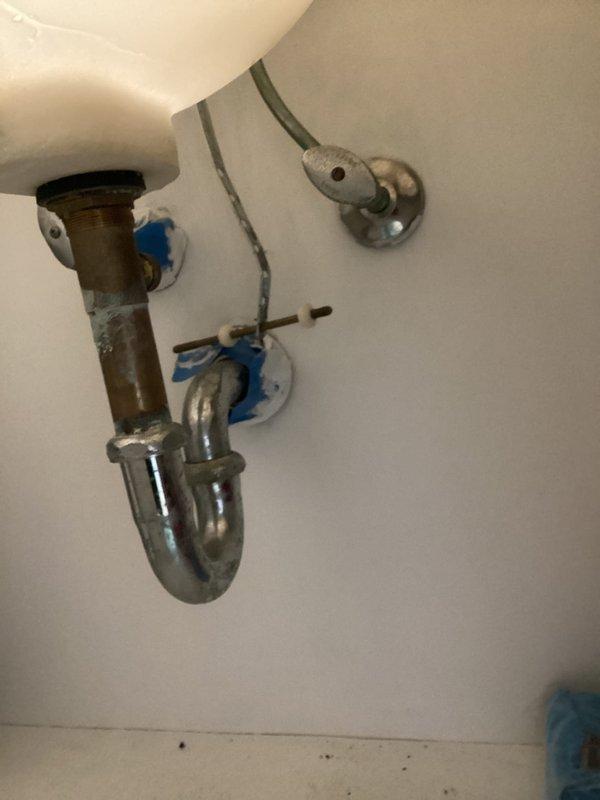 Completed faucet repair in residential bathroom, addressing water supply connection issues. Serviced two-handle chrome faucet assembly, secured water supply lines with proper connections, and verified all plumbing components including P-trap and angle stop valves were functioning correctly. System tested and confirmed operational with no leaks detected.