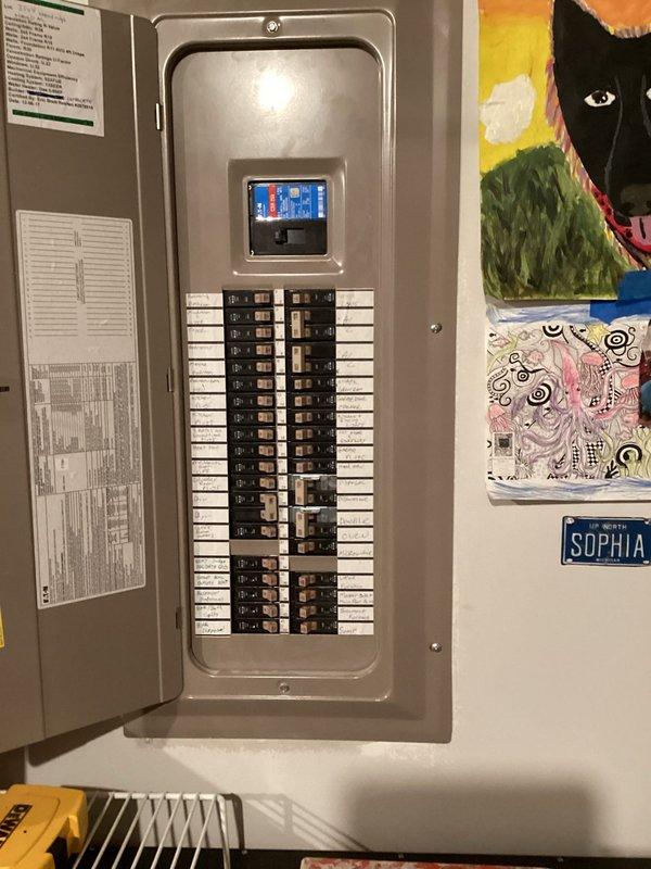 Conducted on-site assessment for electric vehicle charger installation at residential property. Evaluated existing electrical panel capacity and circuit availability, documented panel configuration showing dual-column breaker arrangement with digital monitoring display. Assessed installation location requirements and determined electrical pathway routing from main distribution panel to proposed charging station location in garage area. Provided comprehensive quote for EV charger installation including necessary electrical upgrades and code-compliant installation specifications.