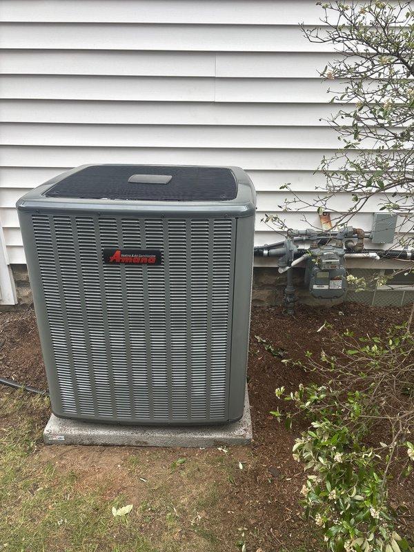 Completed full HVAC system replacement including outdoor condensing unit and indoor furnace components. Installed new Bryant PLUS 90i high-efficiency furnace in basement utility area with proper venting via white PVC piping and condensate drainage system. Mounted new outdoor air conditioning condenser unit on concrete pad adjacent to building exterior with proper clearances from gas meter and siding. Verified all electrical connections, refrigerant lines, and ductwork integration with existing metallic supply ducts. System tested and operational upon completion.