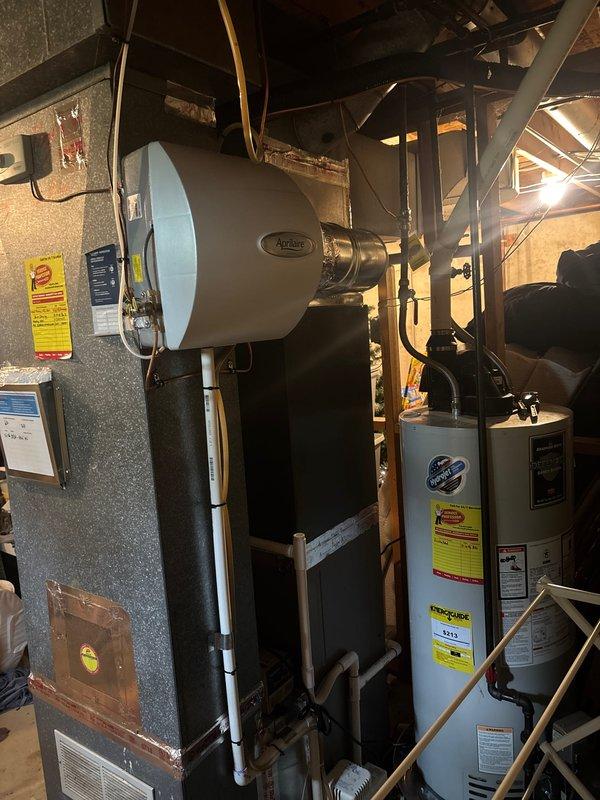 Completed full air conditioning system replacement at residential property. Installed new outdoor condensing unit with proper refrigerant line connections, electrical hookup, and mounting on concrete pad. System tested and verified operational, with all safety labels and manufacturer specifications properly displayed on equipment.
