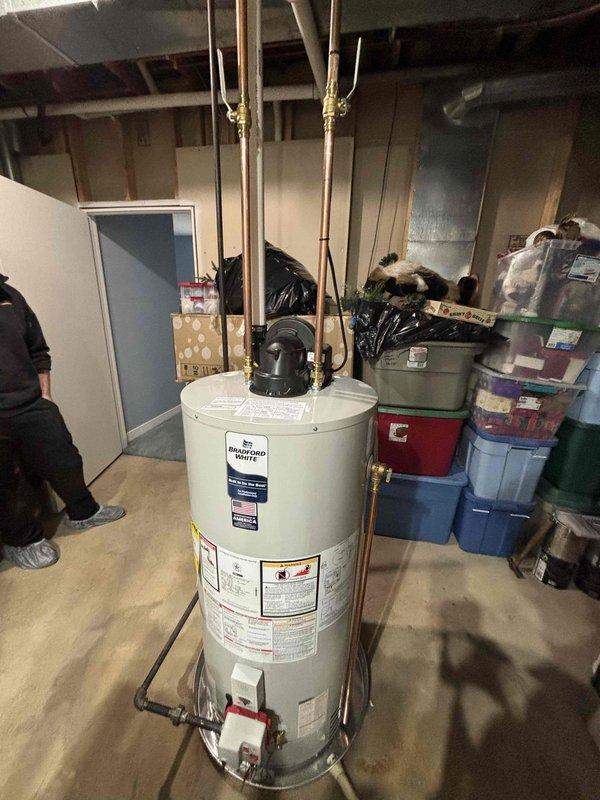 Successfully installed a Bradford White 50-gallon automatic storage water heater in basement utility area. Connected copper supply lines with brass fittings and valves to unit inlet and outlet connections, ensuring proper water flow and system integration. Verified all manufacturer specifications, safety labels, and operational parameters including 38,500 BTU input rating and propane fuel configuration for optimal performance.