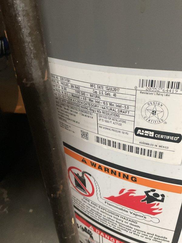Provided estimate for replacement of 40-gallon natural gas water heater manufactured in July 2017 showing visible rust and corrosion on exterior surfaces. Documented current unit condition and specifications, including natural draft venting configuration. Customer requested quote for complete water heater replacement due to age and deteriorating condition of existing unit.