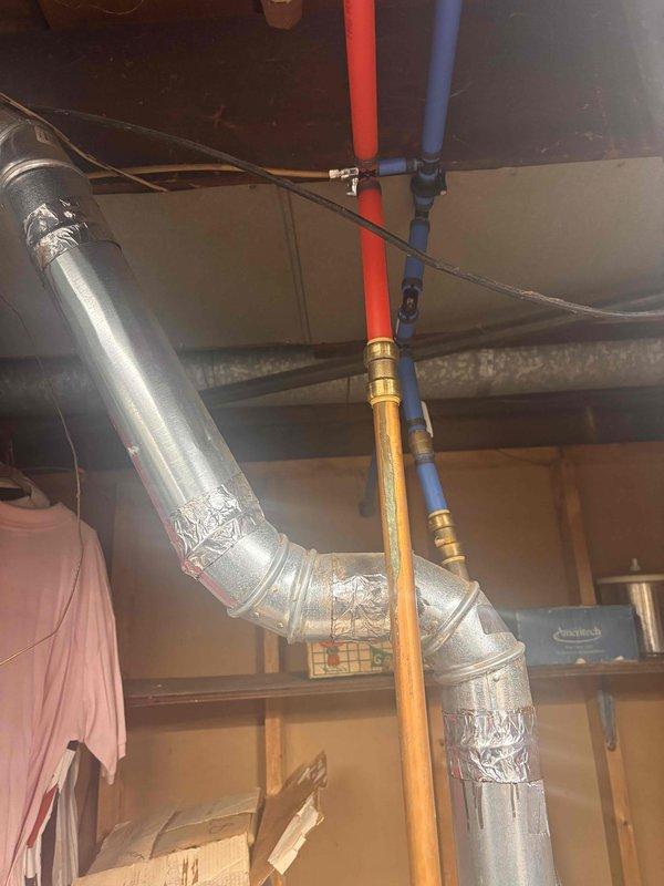 Conducted comprehensive water heater assessment in basement utility area. Evaluated existing plumbing infrastructure including PEX supply lines with shut-off valves, flexible ductwork, and electrical connections. Documented significant structural deterioration in corner section near water heater location, including damaged wooden framing, peeling surfaces, and compromised support materials requiring attention prior to installation. Provided detailed estimate for water heater replacement including necessary modifications to accommodate new unit and address identified structural concerns.