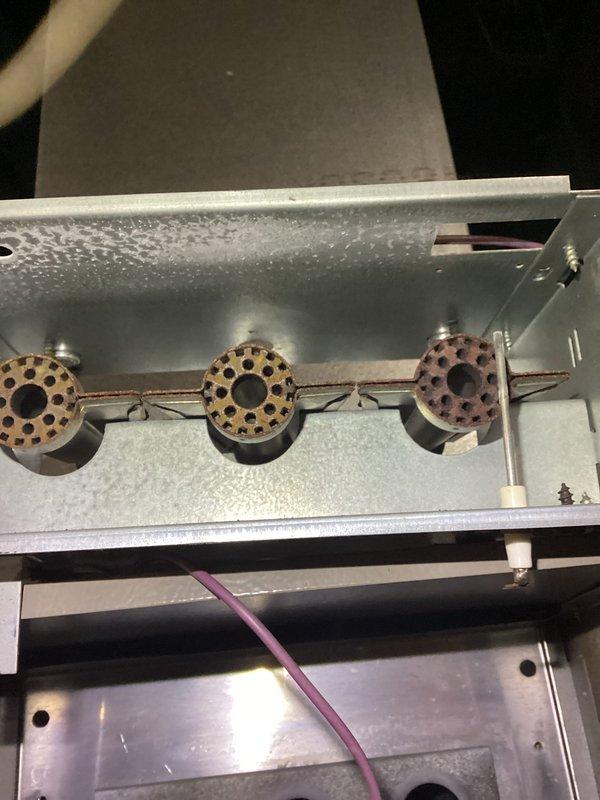 Responded to no heat call at duplex property where furnace had intermittent operation despite thermostat being replaced twice. Upon inspection, found furnace with operational burners and flame sensor showing signs of oxidation and contamination. Cleaned flame sensor, verified proper ignition sequence, and confirmed system returned to normal heating operation with stable burner flame and proper cycling.