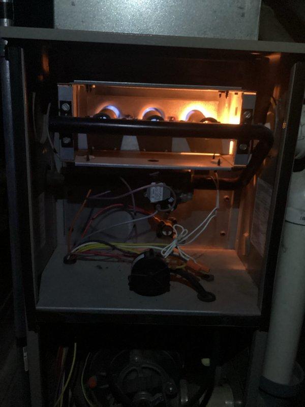 Responded to no heat call at duplex property where furnace had intermittent operation despite thermostat being replaced twice. Upon inspection, found furnace with operational burners and flame sensor showing signs of oxidation and contamination. Cleaned flame sensor, verified proper ignition sequence, and confirmed system returned to normal heating operation with stable burner flame and proper cycling.