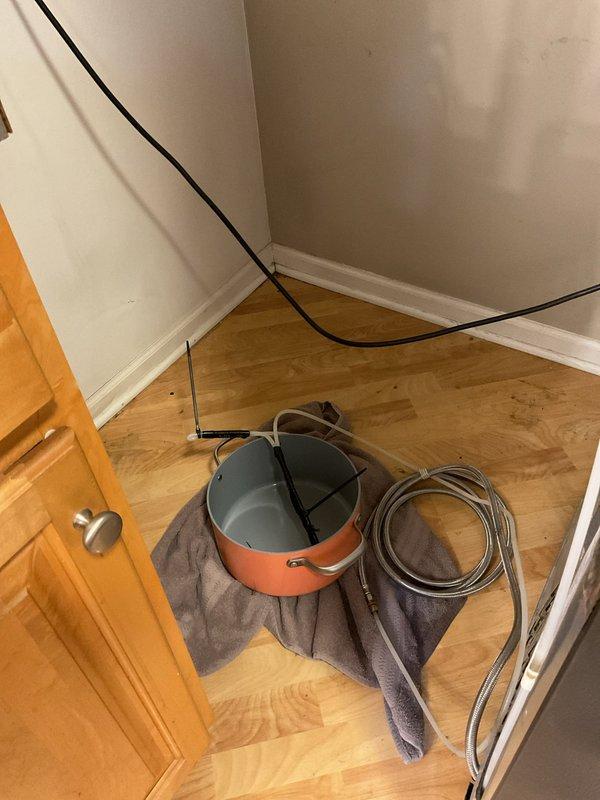 Responded to emergency call for water leaking from refrigerator. Upon arrival, located the water supply line to the refrigerator and successfully shut off the water source to stop the active leak. Placed collection bucket with towel underneath affected area to capture residual water and prevent further damage to flooring. Inspected the refrigerator water line connection and identified the leak source at the supply hose fitting.
