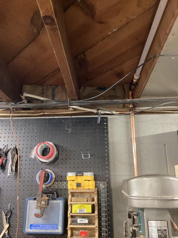 # Water Line Re-Pipe with Water Heater Installation

Completed comprehensive water line re-pipe throughout the residence, installing new copper and PVC piping systems in the basement area. The project included proper mounting and securing of all water lines to floor joists using metal strapping, ensuring code-compliant spacing and support. Successfully installed new water heater with appropriate copper supply lines, brass shut-off valves, and proper venting. All connections were tested for leaks and system was pressurized to verify integrity of the complete re-pipe installation.