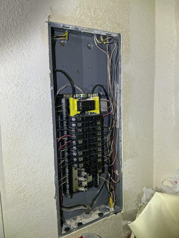 Responded to electrical concerns in recently rewired residence regarding junction box in crawlspace and non-functioning outlet shared between living room and kitchen. Inspected crawlspace junction box connected to garage outlet that homeowner reported feeling static from; verified proper connections and grounding. Tested dual-sided outlet where microwave was previously plugged in, diagnosed issue, and restored functionality. Evaluated electrical panel and grounding system, including exterior ground rod connection with copper conductor. Documented existing two-prong outlet configuration throughout home and provided assessment for potential GFCI protection upgrades at key locations to enhance electrical safety for occupants.