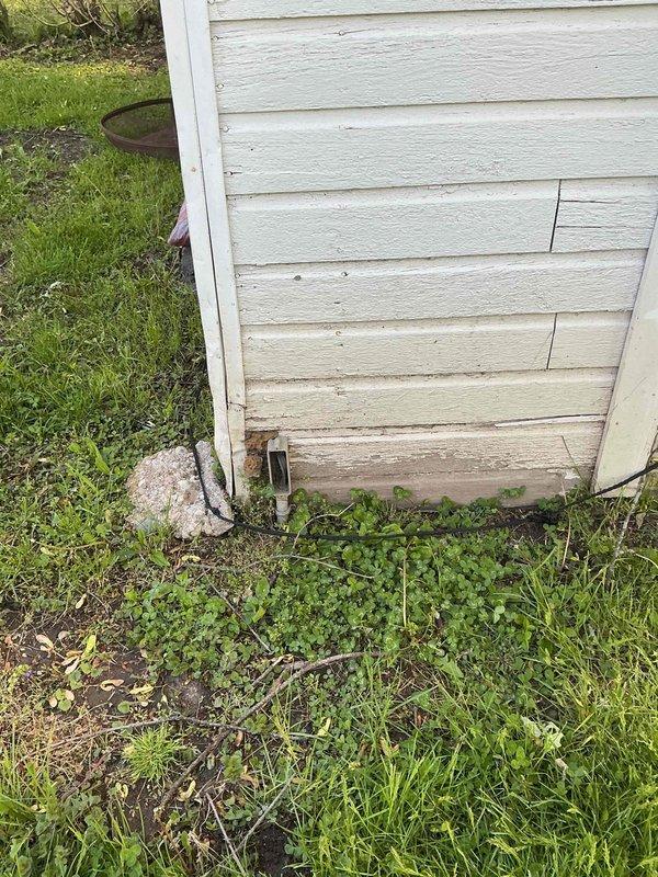 Responded to electrical concerns in recently rewired residence regarding junction box in crawlspace and non-functioning outlet shared between living room and kitchen. Inspected crawlspace junction box connected to garage outlet that homeowner reported feeling static from; verified proper connections and grounding. Tested dual-sided outlet where microwave was previously plugged in, diagnosed issue, and restored functionality. Evaluated electrical panel and grounding system, including exterior ground rod connection with copper conductor. Documented existing two-prong outlet configuration throughout home and provided assessment for potential GFCI protection upgrades at key locations to enhance electrical safety for occupants.