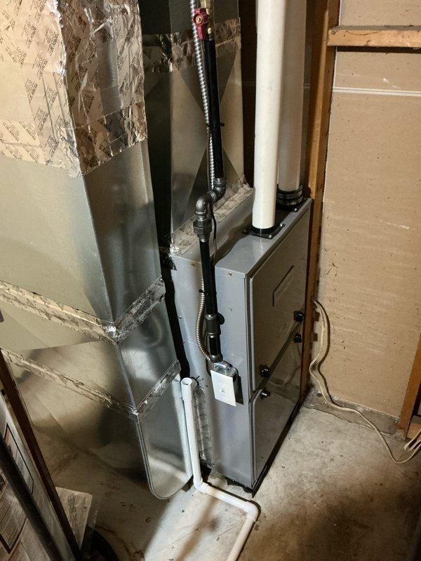 Conducted on-site evaluation for central air conditioning system installation in residential property as part of real estate transaction. Assessed existing forced-air furnace system in basement, documented current HVAC infrastructure including ductwork and electrical service, and photographed installation area to determine equipment requirements and labor scope for complete AC system addition to existing heating system.