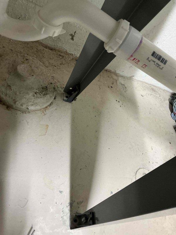 Completed inspector-required corrections including securing laundry sink to floor with appropriate anchoring hardware and installing proper grounding connection to water heater per code requirements. Verified all plumbing fixtures stable and electrical grounding properly bonded to ensure compliance with inspection standards.