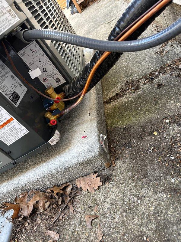 Completed full air conditioning system replacement including outdoor condensing unit installation on concrete pad with proper refrigerant line connections and service valve installation. Installed new electrical disconnect box with appropriate safety labeling and conduit routing to exterior wall. System tested and verified operational with all electrical connections secured and refrigerant lines properly insulated.