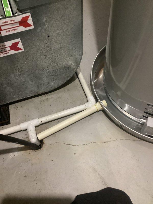 Completed installation of a 40-gallon natural gas Bradford White water heater in basement utility area. Installed unit with proper copper piping connections, brass pressure relief valves, and appropriate venting through existing ductwork. Configured condensate drain system using PVC piping with proper fittings and connections to floor drain. Verified all connections for proper sealing, tested pressure relief mechanisms, and ensured compliance with residential plumbing code requirements for hot water heating systems.