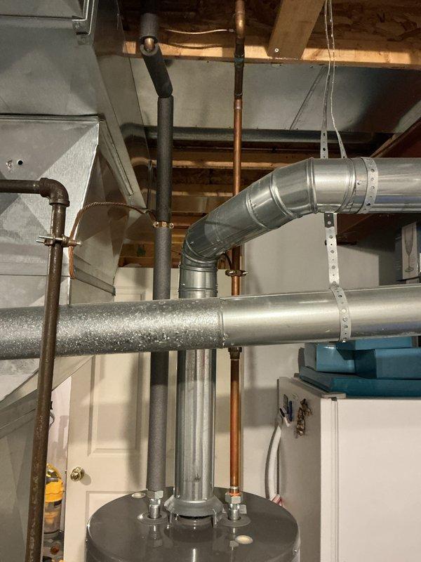 Responded to service call for leaking water heater. Upon arrival, inspected 8-year-old Rheem water heater in basement mechanical room and confirmed active leak. Documented equipment condition and installation with photographs for replacement quote preparation. Advised customer that water heater would likely require replacement due to age and nature of failure.
