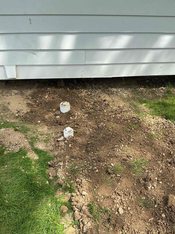 Completed new sewer penetration through building foundation with proper tie-in to existing drainage system. Excavated exterior foundation area, installed PVC piping with appropriate fittings and cleanout access points, and connected interior waste lines using code-compliant couplings and transitions. All penetrations sealed and system tested for proper drainage flow.
