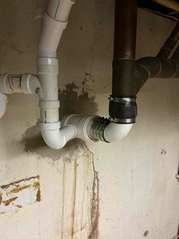 Completed new sewer penetration through building foundation with proper tie-in to existing drainage system. Excavated exterior foundation area, installed PVC piping with appropriate fittings and cleanout access points, and connected interior waste lines using code-compliant couplings and transitions. All penetrations sealed and system tested for proper drainage flow.