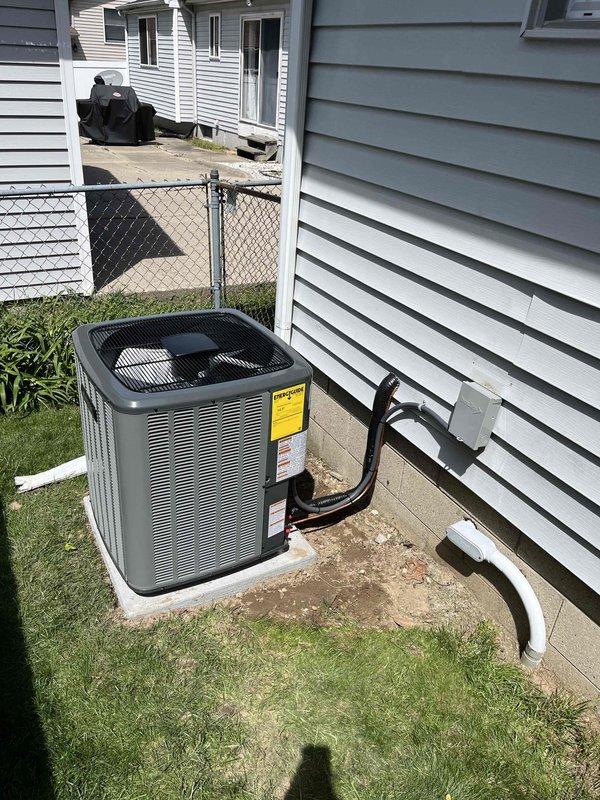 Completed full HVAC system installation including new furnace and air conditioning unit. Interior furnace installed in utility room with proper PVC venting and ductwork connections. Exterior condensing unit positioned on concrete pad with refrigerant lines, electrical disconnect, and condensate drain line properly installed through exterior wall. All equipment tested and verified operational upon completion.