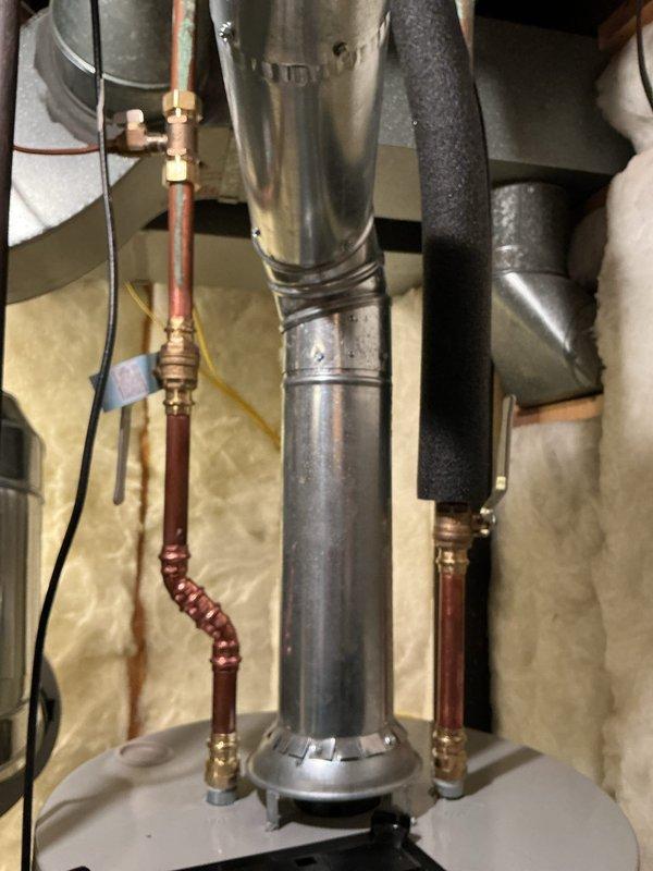 Completed installation of a 40-gallon natural gas water heater (tall model, 10-year tank/10-year parts warranty) in basement utility area. Established all plumbing connections using copper piping with brass compression fittings, installed proper venting through metallic ductwork, and verified all gas line connections for safe operation. Unit tested and operational upon completion.