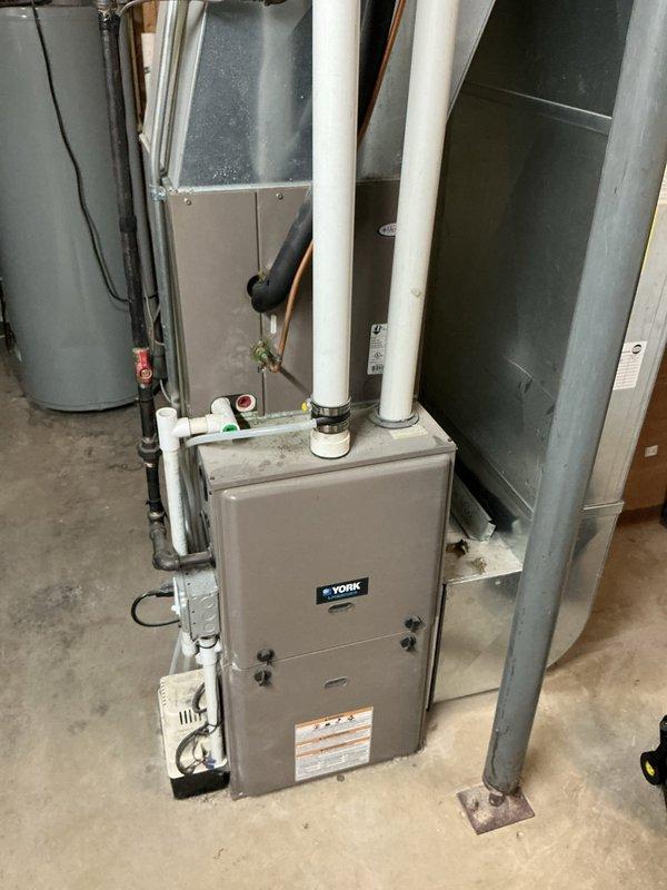 Responded to no cooling complaint with unit freezing up. Previous contractor diagnosed evaporator coil leak and recommended full system replacement due to R22 refrigerant. Upon inspection, confirmed York furnace with 2-year-old evaporator coil paired with outdoor condensing unit model YCJD36S41S1A utilizing R-410A refrigerant. Documented equipment specifications and current system configuration with photos for assessment and recommendations.