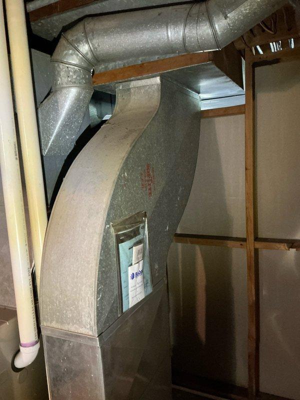 Responded to service call for water heater producing lukewarm water with no visible leaks. Performed comprehensive evaluation of 9-year-old water heater system and inspected all plumbing connections, pressure relief valve, and heating elements. Assessed HVAC system including furnace and air conditioning equipment in utility area. Documented equipment conditions through photographic records showing water heater installation with copper piping connections, pressure relief valve, and associated ductwork. Provided customer with detailed repair versus replacement options through Guard Home Warranty to address temperature maintenance issues.