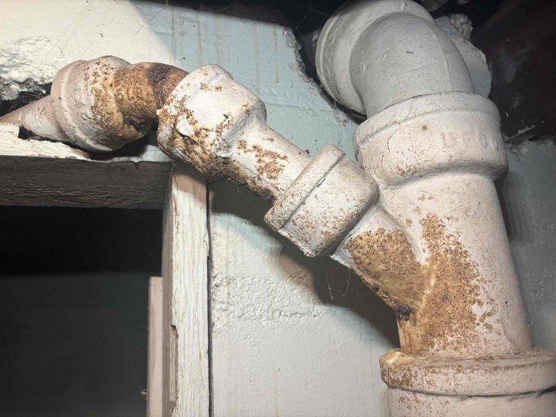 # AC Annual Cooling Maintenance - Lennox System

Completed annual cooling maintenance on a 2016 Lennox air conditioning unit with 22 years of service history. Performed comprehensive system inspection including refrigerant levels, electrical connections, condensate drain operation, and overall unit performance. 

During inspection, documented existing plumbing infrastructure conditions in the vicinity of the HVAC system. Observed galvanized steel piping with visible corrosion, rust deposits at threaded connections, and mineral buildup at pipe joints. Noted aging pipe fittings showing oxidation and deterioration that may require future attention from a licensed plumber.

System operational testing confirmed air conditioning unit is functioning within normal parameters. All safety controls verified operational. Photographic documentation captured for maintenance records.