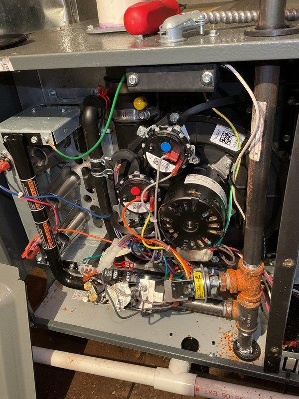 Completed annual heating maintenance on furnace system installed in basement crawl space. Performed comprehensive tune-up including inspection of blower motor assembly, electrical connections, and ductwork connections. Verified all wiring connections secure, checked capacitor condition, inspected internal components including motor and control board with indicator lights, and confirmed proper system operation. Unit placement verified as acceptable, no humidifier present on system. Equipment covered under 1-year EnergiAir warranty valid through May 2034.