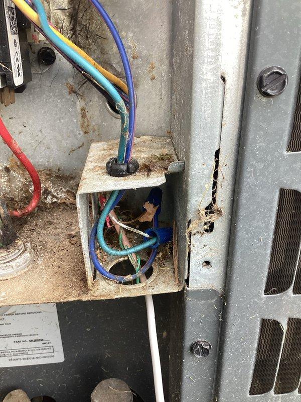 Completed annual cooling maintenance on 4-year-old air conditioning system. Performed comprehensive inspection of outdoor condensing unit, documenting electrical connections and internal components. Removed significant accumulation of grass clippings, leaves, and organic debris from unit base that had collected around electrical components and wiring. Inspected capacitor and wiring connections, noting visible corrosion and rust on electrical junction terminal block and metal panel surfaces. Assessed condition of all wire connections including power supply conductors. Photographed areas of concern including corroded terminal connections and deteriorated metal surfaces showing oxidation from moisture exposure. System operational at time of service completion.