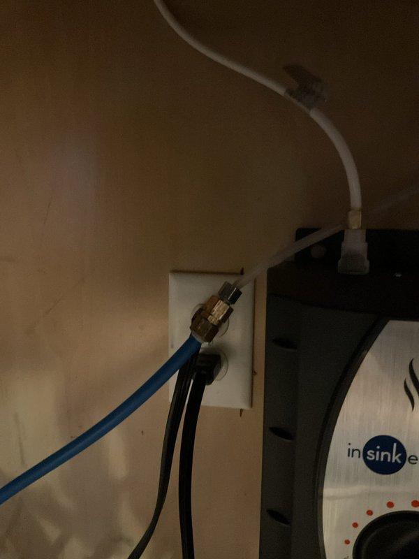 Installed customer-supplied instant hot water dispenser system under kitchen sink, including mounting the InSinkErator heating tank unit and connecting associated electrical and plumbing components. Completed installation with functional testing to verify proper operation of the hot water dispenser and faucet assembly.