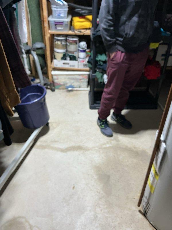 Responded to emergency water heater leak with active flooding in basement utility area. Upon arrival, confirmed water and electrical power had been safely shut off to the 16-year-old Bradford White unit. Assessed the extent of water damage to surrounding floor area and documented conditions with photographs. The water heater, which had been functioning normally prior to the leak, showed signs of tank failure consistent with its age beyond typical service life expectancy. Verified all utilities remained secured and area was safe, preventing further water damage to the space and stored items.