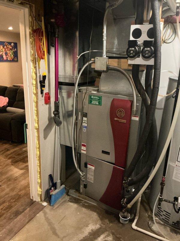 Conducted estimate for replacement of 17-year-old geothermal HVAC system in residential basement installation. Customer exploring multiple heating options including conversion to natural gas furnace or boiler system as alternatives to geothermal replacement. Documented existing equipment configuration including geothermal unit, ductwork connections, and associated mechanical components with photographic records for proposal development.