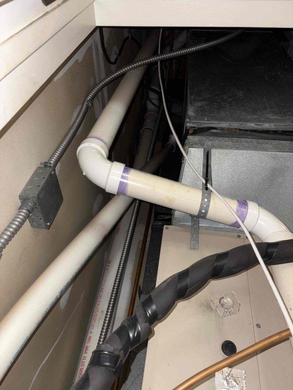 Responded to no-heat call for two 18-year-old furnaces at residential property. First unit was completely unresponsive with no power to control board; second unit had power but failed to ignite. Performed diagnostic testing on both Comfort-Maker furnace systems, inspecting blower motor assemblies, electrical connections, gas valve operations, and ignition components. Documented existing conditions of both units including PVC condensate drainage, flexible conduit routing, and internal cabinet components through photographic evidence for customer records.