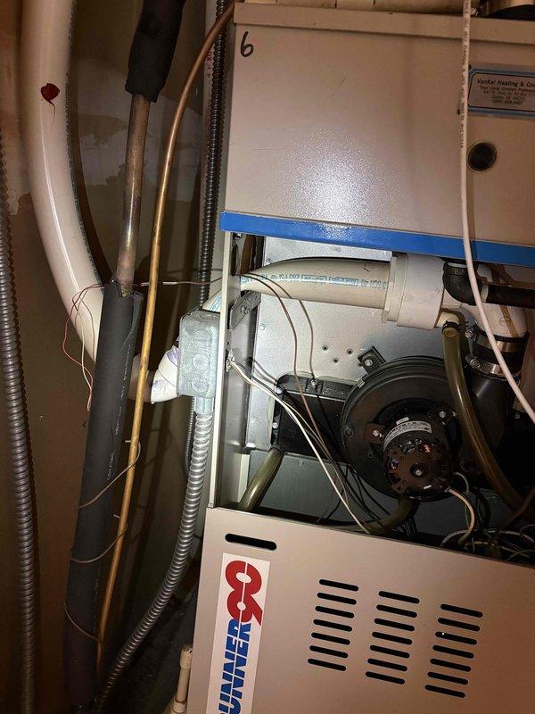Responded to no-heat call for two 18-year-old furnaces at residential property. First unit was completely unresponsive with no power to control board; second unit had power but failed to ignite. Performed diagnostic testing on both Comfort-Maker furnace systems, inspecting blower motor assemblies, electrical connections, gas valve operations, and ignition components. Documented existing conditions of both units including PVC condensate drainage, flexible conduit routing, and internal cabinet components through photographic evidence for customer records.