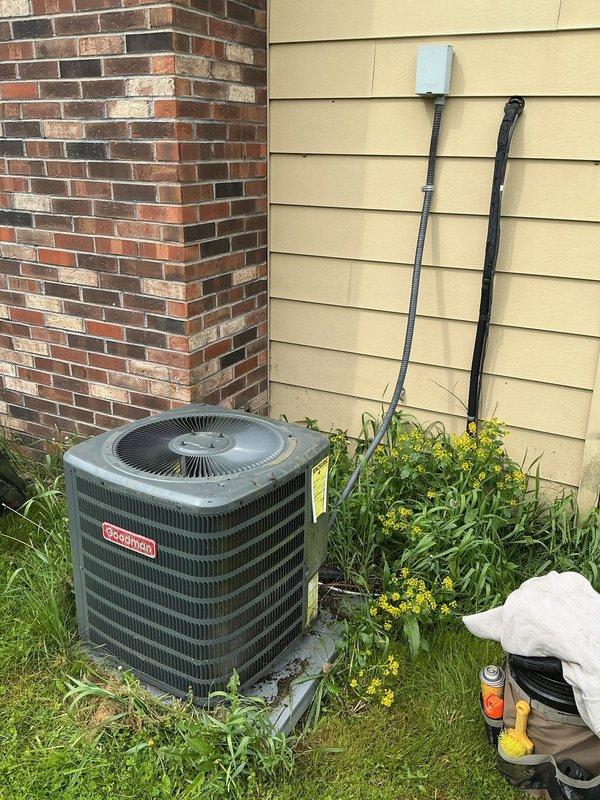 Completed comprehensive ASTU-AC Super Tune-up on 9-year-old Goodman residential air conditioning system as preventative maintenance before summer season. Performed full system inspection of outdoor condenser unit, checked electrical connections and disconnect box, verified refrigerant levels, cleaned condenser coils, inspected conduit lines, and tested overall system performance to ensure optimal cooling efficiency. All components found to be operating within normal parameters with no issues identified.
