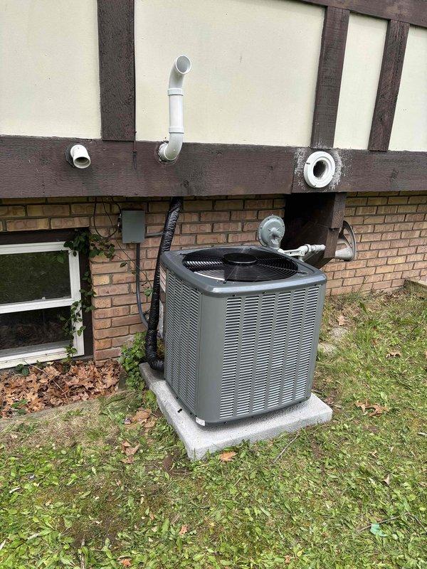 Completed full HVAC system installation including new furnace and air conditioning unit. Installed outdoor condensing unit on concrete pad with proper refrigerant line connections and PVC condensate drain line routed along exterior wall. System was charged with refrigerant, pressure-tested using manifold gauges to verify proper operating pressures, and all electrical connections were completed per manufacturer specifications.