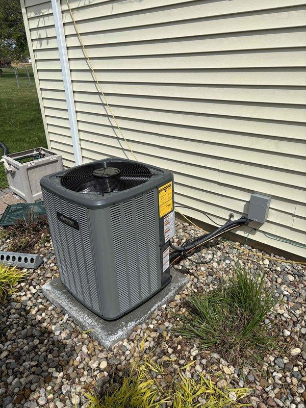 Successfully completed full HVAC system installation including new Amana furnace and outdoor air conditioning condenser unit. Installed furnace in basement utility area with proper PVC venting routed through ceiling joists to exterior. Mounted outdoor AC condenser on concrete pad with appropriate electrical disconnect and conduit installation on exterior wall. Connected refrigerant lines between indoor and outdoor units, completed all electrical connections per manufacturer specifications, and verified proper drainage routing. System tested and confirmed operational with all safety controls functioning correctly.