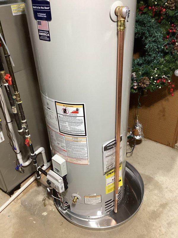 # Water Heater Installation

Successfully completed a residential water heater replacement in a basement utility area. Removed the existing water heater and installed a new Bradford White water heater unit manufactured in the USA. Established all required plumbing connections using copper piping with brass fittings at the top of the unit. Installed pressure relief valve and proper discharge piping to code specifications. Connected hot and cold water supply lines with appropriate shut-off valves for system isolation. Verified all connections for proper sealing and tested for leaks. Ensured the water heater was level and properly positioned on the concrete floor with adequate clearance for ventilation and service access. Connected gas supply line with appropriate safety shut-off valve. Tested all safety controls including temperature and pressure relief valve operation. Filled the tank, purged air from the system, and verified proper heating function. Confirmed all manufacturer specifica