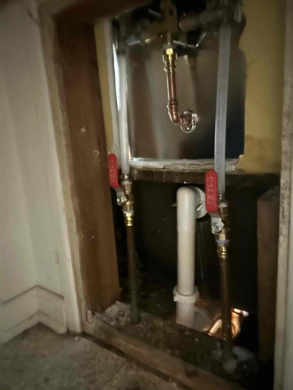 Replaced defective shower valve assembly in bathroom tub/shower combination. Removed existing chrome octagonal trim plate and valve mechanism, accessed plumbing through wall cavity, installed new valve with updated trim plate, and reconnected supply lines with shut-off valves. Tested operation to ensure proper water flow and temperature control functionality.