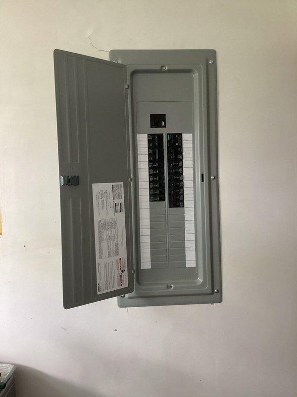 Completed 200-amp electrical service upgrade at residential property. Coordinated utility company power disconnect and reconnect to facilitate safe installation of new service panel. Obtained electrical permit and scheduled required inspections, which were completed and approved. Installed new gray circuit breaker panel with main breaker and dual columns of individual circuit breakers, mounted securely to interior wall. All work performed to current electrical code standards with proper labeling and documentation affixed to panel interior. Power restoration confirmed following successful inspection approval.
