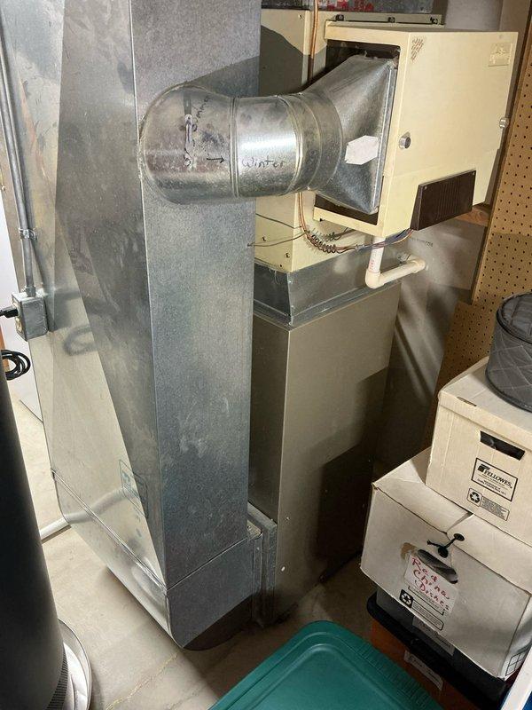 Conducted sales estimate for residential air conditioning system at property with existing forced-air HVAC installation in basement utility area. Evaluated current furnace unit with metal ductwork distribution system, copper refrigerant lines, and PVC condensate drain configuration. Documented existing equipment layout including sheet metal duct assembly, cylindrical duct components, and humidifier units to provide customer with accurate quote options for AC system integration with operational heating equipment.