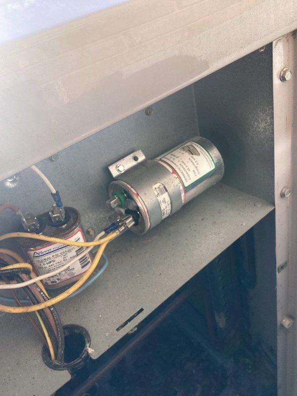 Completed annual cooling maintenance on 16-year-old air conditioning system. Performed comprehensive inspection of electrical components including dual capacitor assembly and wiring connections, documented system condition with photos showing capacitors, wire terminals, and control panel interior. All components found in acceptable working order for continued operation.