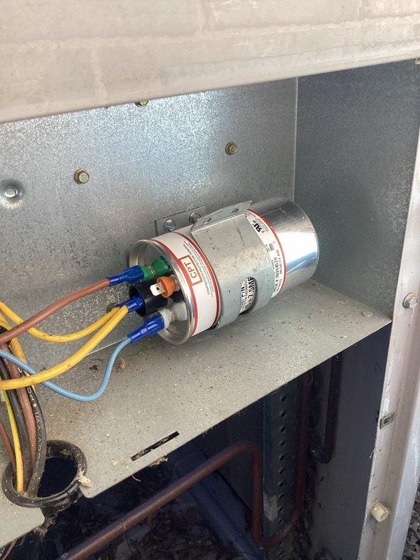 Completed annual cooling maintenance on 16-year-old air conditioning system. Performed comprehensive inspection of electrical components including dual capacitor assembly and wiring connections, documented system condition with photos showing capacitors, wire terminals, and control panel interior. All components found in acceptable working order for continued operation.