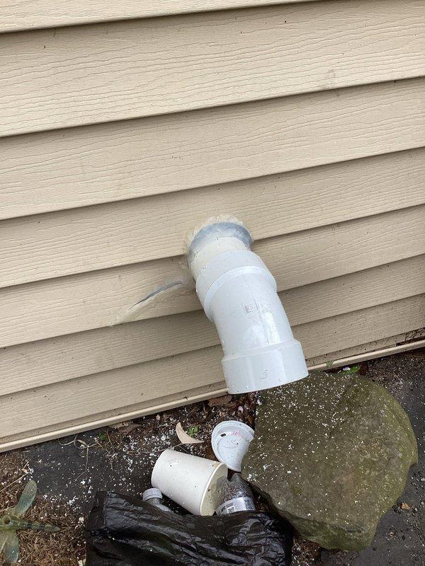 Completed water heater venting repair and replacement. Installed new white PVC venting components at exterior foundation level and reconfigured interior mechanical room piping system. Properly primed and fitted all PVC joints with appropriate elbows, couplings, and support brackets to ensure code-compliant exhaust ventilation for water heater operation.