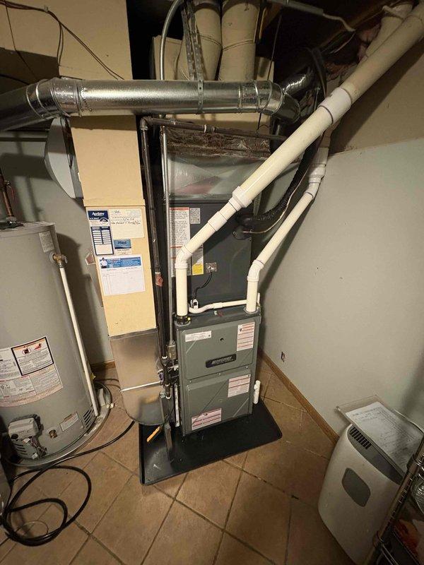 Completed full system replacement of residential furnace and air conditioning unit. Installed new furnace in basement mechanical room with proper venting and drainage connections via PVC piping, mounted unit on stable platform with all required safety labels and specifications visible. Replaced outdoor AC condensing unit, charged refrigerant system to manufacturer specifications as verified by manifold gauge readings showing proper pressures across all zones. All ductwork secured, electrical connections completed, and system tested for proper operation.