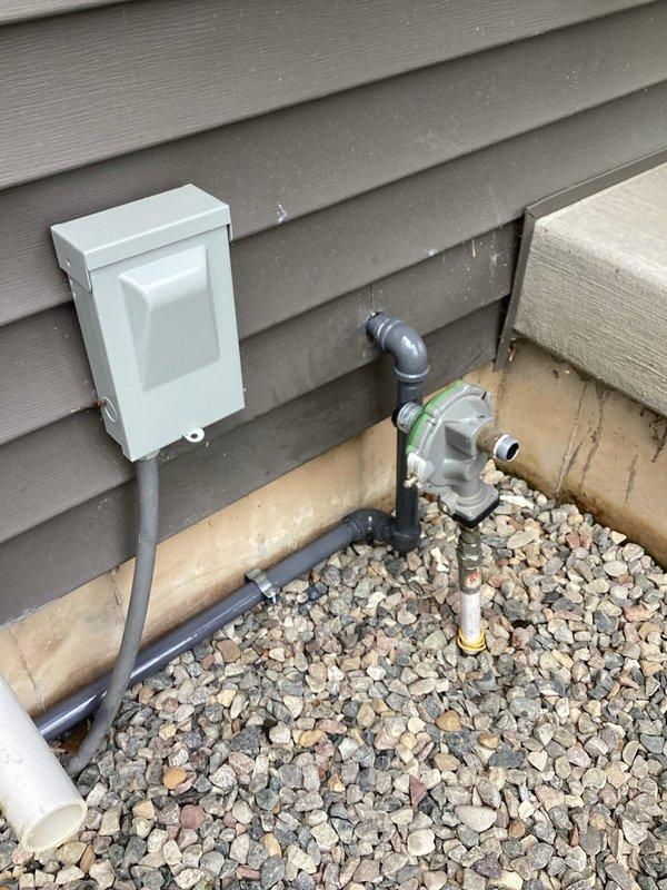 Completed conversion of residential gas system from liquid propane (LP) to natural gas (NG). Replaced gas meter assembly with NG-compatible unit, installed new black iron piping with appropriate fittings and connections, and verified proper operation of all gas appliances. All work performed in accordance with local codes and manufacturer specifications, with photographic documentation of completed exterior meter installation and workspace setup.