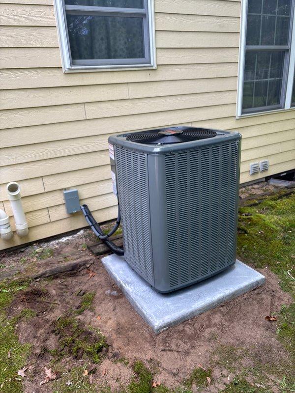 Completed full system replacement including new furnace and air conditioning condenser unit. Installed furnace in basement utility area with proper venting via white PVC piping, mounted on platform base with all ductwork connections secured and integrated with existing distribution system. Positioned new outdoor AC condenser on concrete pad with refrigerant lines and electrical conduit properly routed through exterior wall, junction box mounted, and all connections tested for proper operation.