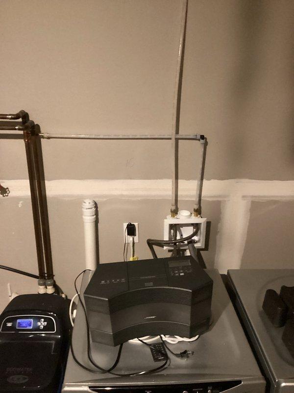 Completed laundry room addition installation including all necessary plumbing connections for new front-loading washing machine. Installed water supply lines, drain connections, and verified proper operation of the appliance in the utility room space.